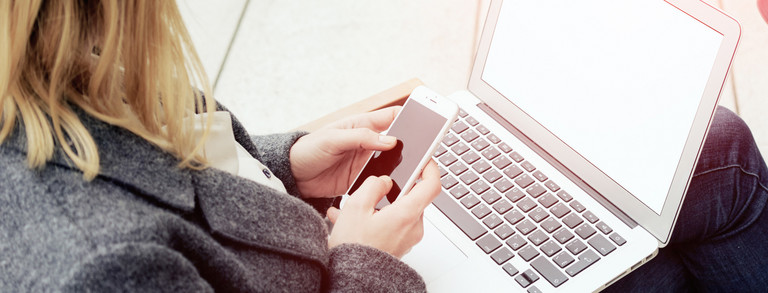 A woman has a laptop on her lap