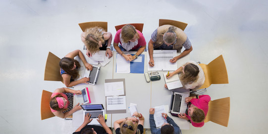 People sitting in a circle talking shot from above.